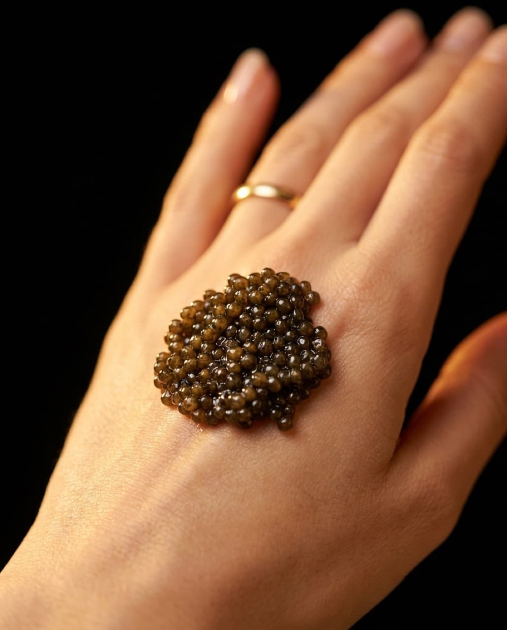 A bump of caviar served on the hand